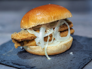 Fish burger made with roasted hering and fresh onions