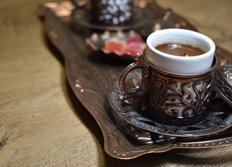A cup of traditional turkish coffee and turkish delight on wooden surface served at Istanbul
