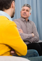 Adult father and son solve problems