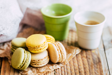 Macarons saveur vanille pistache et citron sur une table en bois