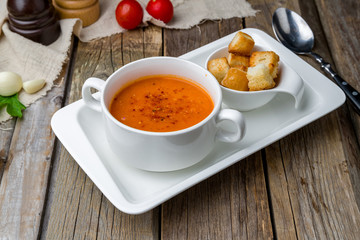 Soup cream of tomato on wooden table