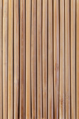 Japanese wooden chopsticks folded together form a continuous background . View from above.
