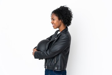 Young African American woman with a motorcycle helmet isolated on white background looking to the side