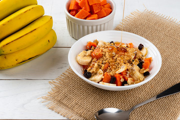 Using maple syrup in a bowl with fruit. Breakfast concept.
