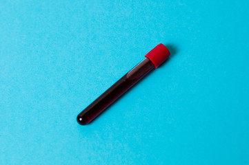 Test tube with blood isolate on a blue background