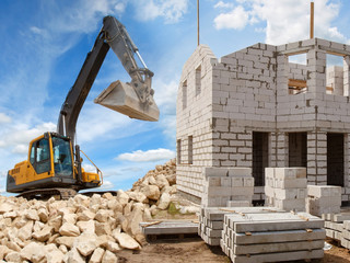 The Builder carries the boards. A man in an orange vest, constru