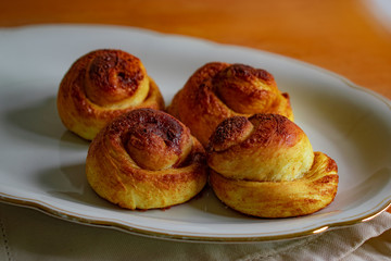 sweet cakes on a plate, food background. soft focus of cinnamon rolls on white dish