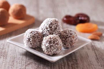 Hand made energy balls in a plate on the table. Homemade healthy sweets. Concept: healthy eating.