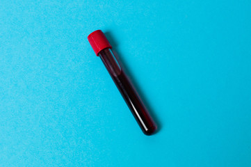 Test tube with blood isolate on a blue background