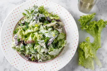 Fresh lettuce with yogurt and chives on a plate