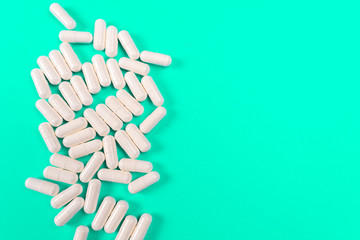 white tablets on a turquoise background. isolate