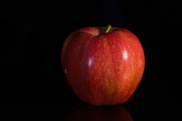 red apple on black background