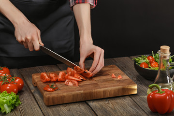 Woman cooking fresh vegetable salad. Female hands. Diet concept for healthy lifestyle with copyspace.