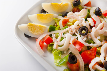 healthy salad in a white plate on a white background. Healthy eating Salad close up