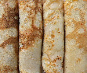 handmade crepes or pancakes baked recipe, closeup rolled up sweet breakfast or dessert texture