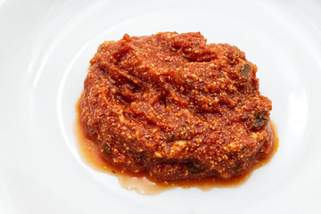 Red tomatoe sauce on a white dish	

