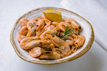 Fried Tiger prawns server with lemon on white table