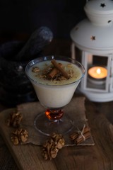  rice pudding on wooden background with candle and walnut