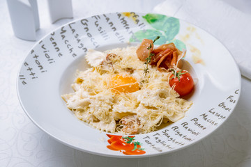 Pasta Carbonara with bacon on white plate