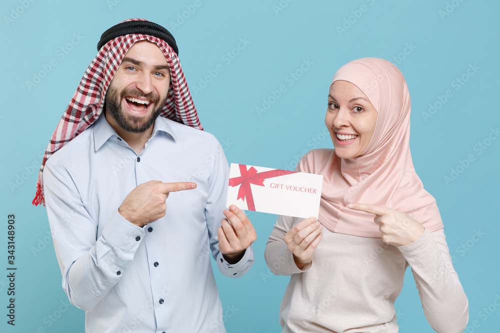 Wall mural funny couple friends arabian muslim man wonam in keffiyeh kafiya ring igal agal hijab clothes isolat