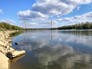 Blue sky with clouds over a river.