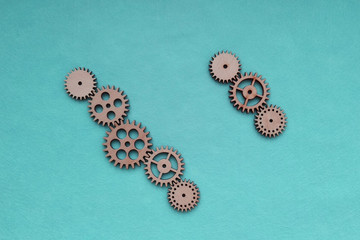 Wooden gears on a blue background. Concept of interaction.