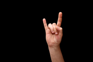 hand raised up with fingers in the shape of devil symbol.