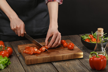 Woman cooking fresh vegetable salad. Female hands. Diet concept for healthy lifestyle with copyspace.
