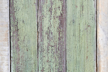 Vintage planks arranged vertically painted by old green paint.