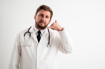 Male doctor with stethoscope in medical uniform showing call me gesture