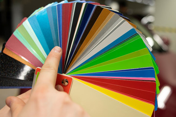 Master selects color from palette of vinyl films swatches for car wrapping