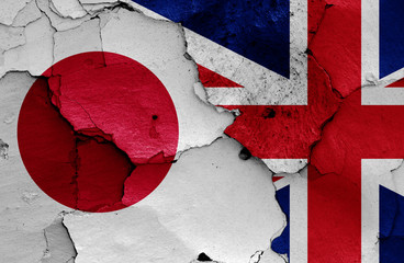flags of Japan and UK painted on cracked wall
