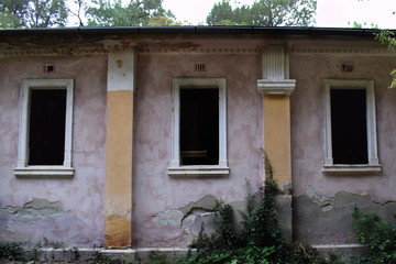 Fototapeta na wymiar Three windows in an abandoned building