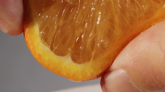 squeeze orange juice with fingers, citrus fruits, background video, squeezing juice closeup