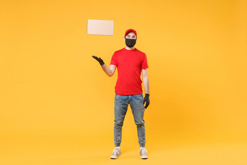 Delivery man employee in red cap blank t-shirt uniform face mask glove hold empty cardboard box isolated on yellow background studio Service quarantine pandemic coronavirus flu virus 2019-ncov concept