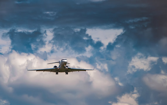 Business jet in the cloudy sky