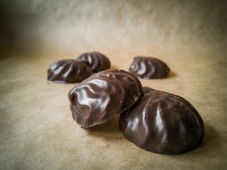 White marshmallows in chocolate on parchment paper