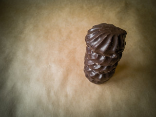 White marshmallows in chocolate on parchment paper