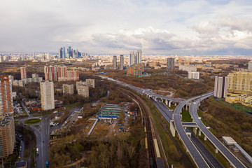 Naklejka premium panoramic view with skyscrapers and highways of a big city filmed from a drone