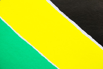 Green, yellow and black torn pieces of cardboard paper background with copy space for text message.