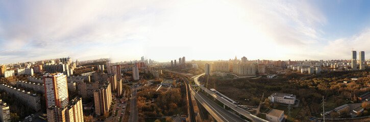 Naklejka na ściany i meble panoramic view with skyscrapers and highways of a big city filmed from a drone