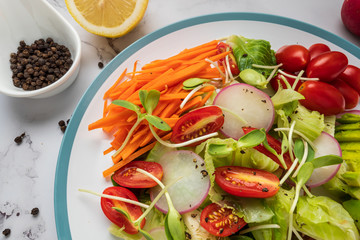 healthy vegan bowl. Avocado, tomato, Red Radish,carrot, Sunflower seedling,Black pepper, lemon,  and vegetables salad. Top view. vegan food, clean eating, dieting