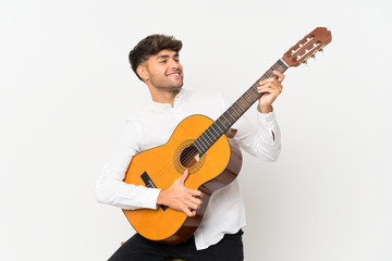 Young handsome man with guitar over isolated white background