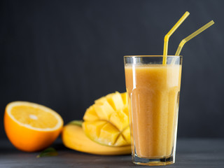 Fresh juicy delicious mango smoothie with orange and banana