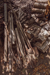 Pile of wood. Mess of old shovels, woods and dirty tree branches. Rustic textures
