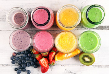 Assortment of fruit smoothies in glass bottles. Fresh organic Smoothie ingredients. Smoothies for health or detox diet food
