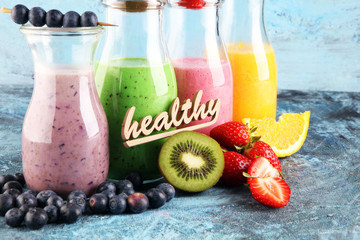 Assortment of fruit smoothies in glass bottles. Fresh organic Smoothie ingredients. Smoothies for health or detox diet food