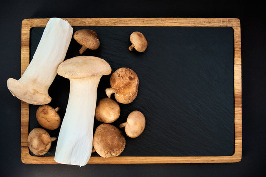 shiitake and eringi mushrooms on black background