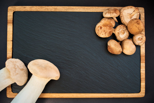 shiitake and eringi mushrooms on black background