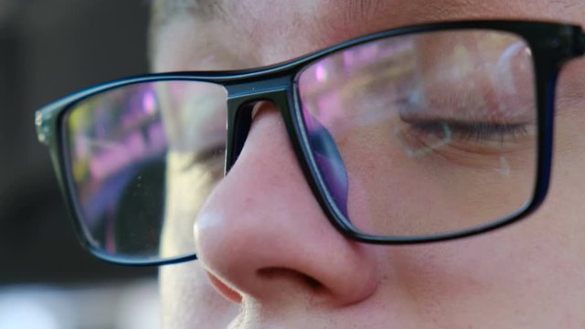 A man touches his eyes with his hands and scratches them, close-up. Failure to comply with hygiene and precautions during the coronavirus pandemic